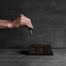 Hand applying Aoiro Hakudo Rain cork diffuser oil on cork cubes