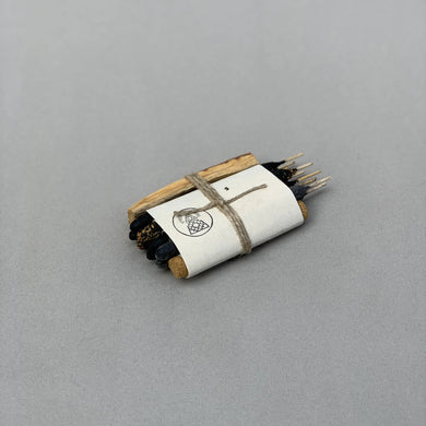 Roll of incense with a label on a gray background