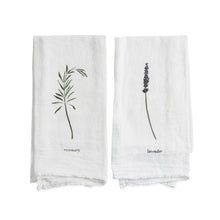 Two white towels with black botanical illustrations and text on a white background