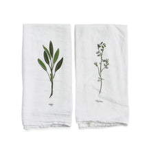 Two white towels with green leaf illustrations and text on a white background