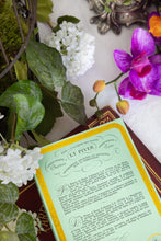 Vintage-style box with decorative floral elements on a white surface