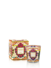 Decorative candle with matching box featuring intricate designs on a white background