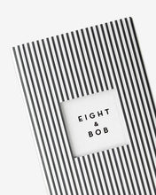 Black and white striped notebook with 'EIGHT & BOB' branding on a white background