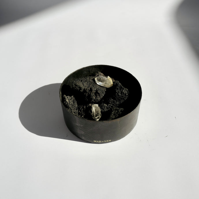 Mad et Len Potpourri - Lava Crystal Flat Petite. Lava rocks and crystals in metal forged cylinder flat container. Gold appliqué branding. 