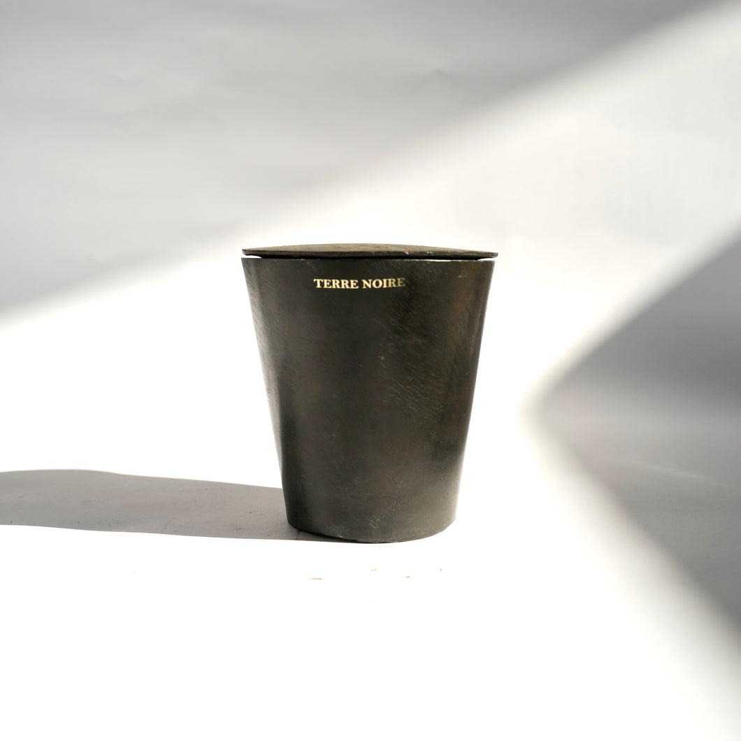 Black tapered metal Mad et Len Bougie Vestimentale Petite in Metal Casing - Terre Noire candle with lid. 