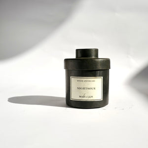 Black metal cylinder Mad et Len Candle Apothicaire Petite - NIGHT SOUK - with matching lid cover. 