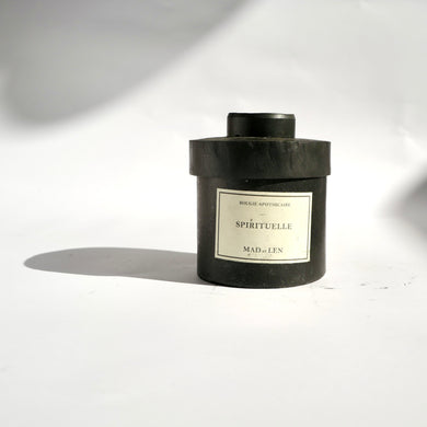 Black metal cylinder Mad et Len Candle Apothicaire Petite - SPIRITUELLE. Matching lid covering the candle. 