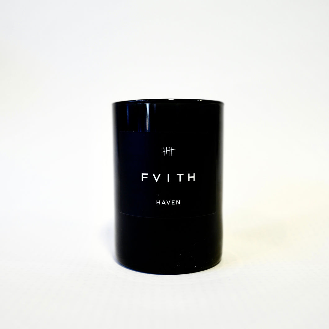 Haven Fragrance Candle in black glass container with brand label. 