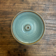 Sage green ceramic Incense Holder on a wood table. 
