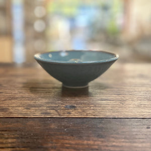 Sage green ceramic Incense Holder on a wood table. 