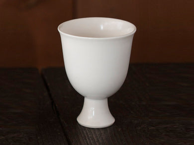 SAKE Vessel with Stem HOSOMI on wood table. 