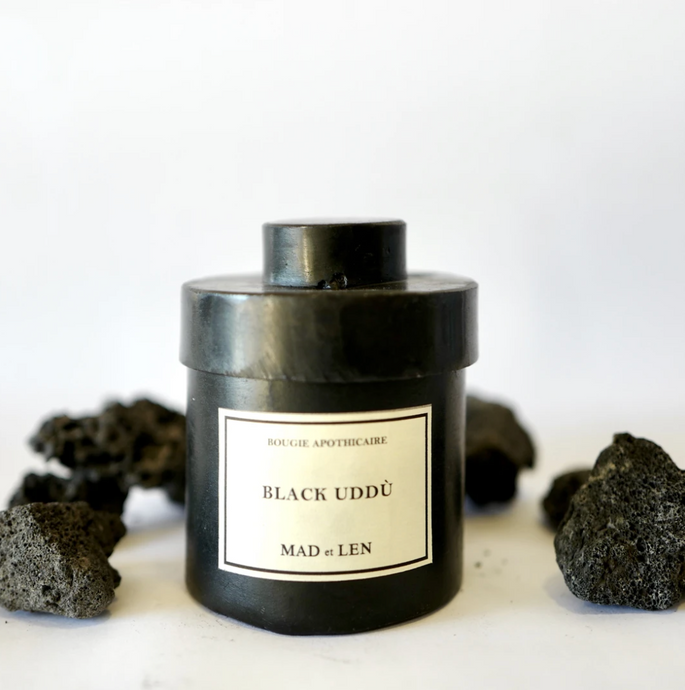 Black metal cylinder Mad et Len Candle Apothicaire Petite - BLACK UDDÙ - with matching lid cover. Lava rocks on the side. 