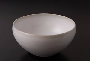 Low Japanese Bowl in a dark background. Snow inspired glaze color with rim highlight. 