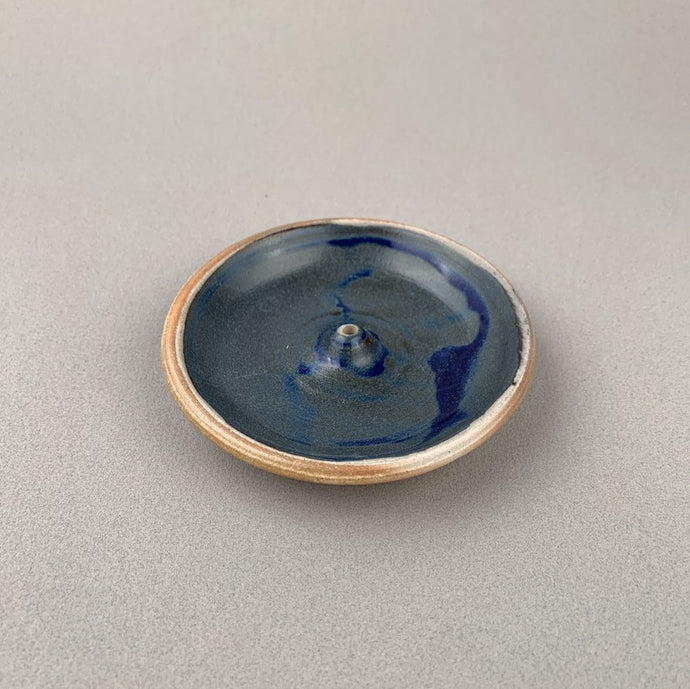 Blue Incausa Stoneware Woodfired Holder in plain background. 