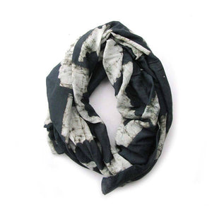 A coiled Sunset Scarf with white and grey colors.