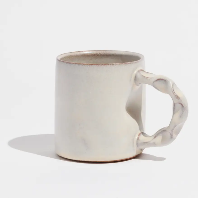 Ceramic Mug with sculpted handle in cream color