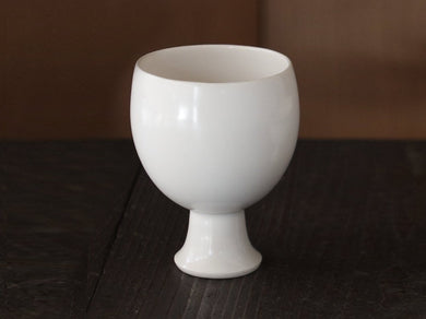 Sake Vessel with Stem Subomi on wood table. 